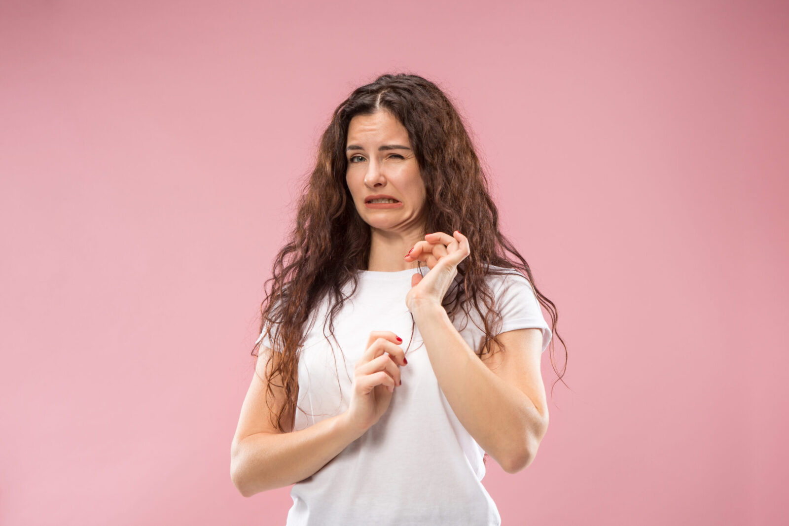 Young Woman With Disgusted Expression Repulsing Something, Isolated On The Pink