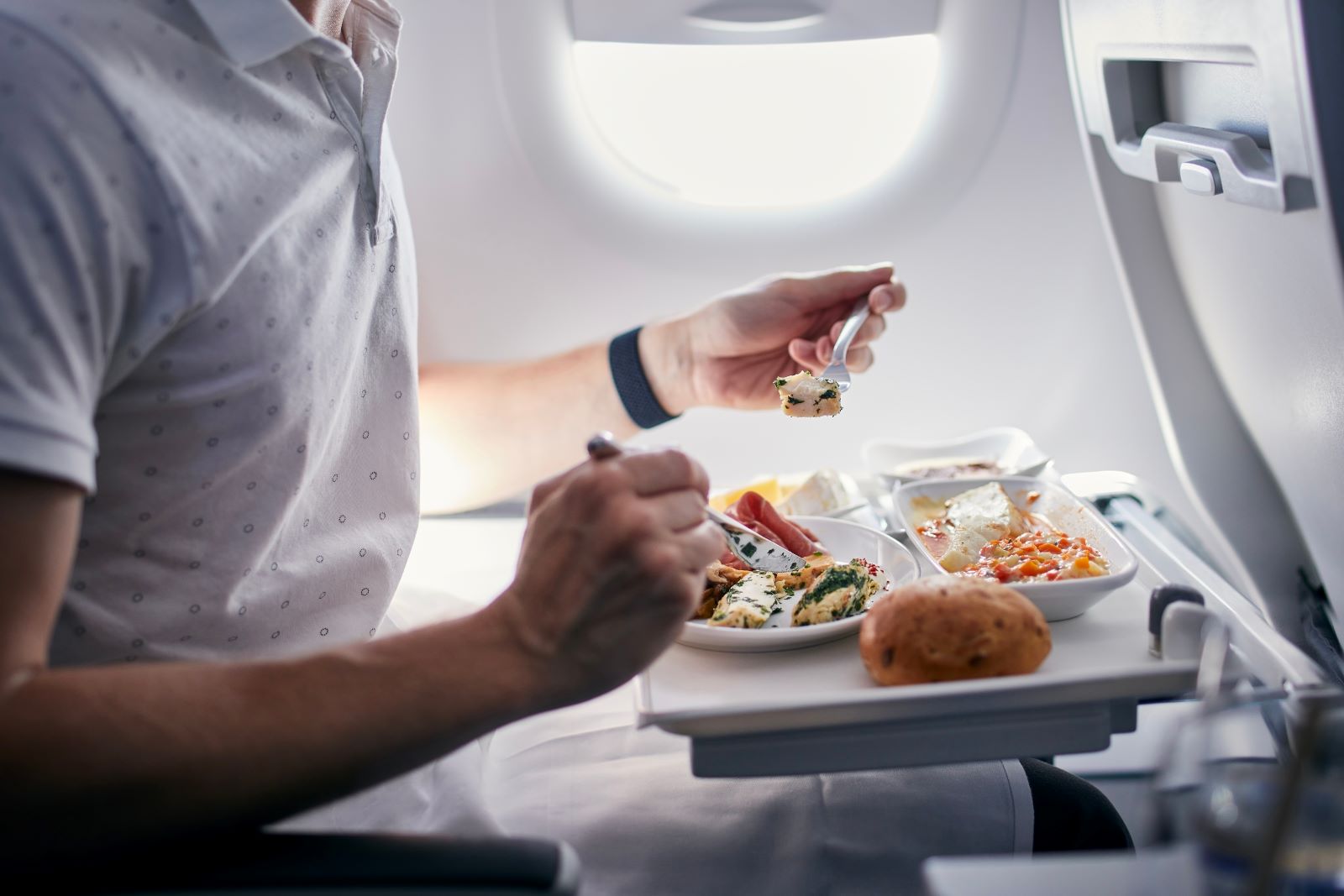 Man Eating In A Plane